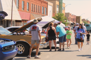 crowd of people looking at classic cars