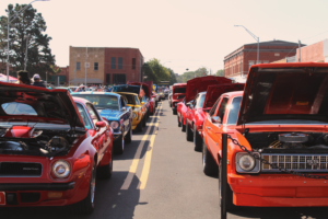 artistic photo of cars lined up at car show