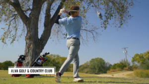 young man swinging a golf club