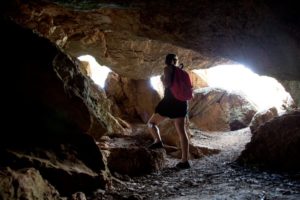woman hiking in a cave