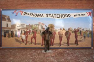 oklahoma statehood mural with statue of a trombone player